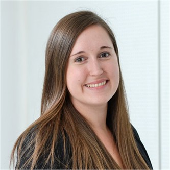 Stephanie Hawthorn in a black top, in front of a pale background