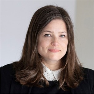 Zoe Fleetwood in a white formal shirt, black top with a grey background.