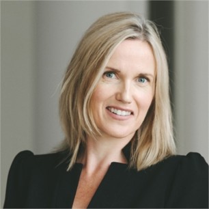 Joanna Grandfield in a black jacket, in front of a grey background