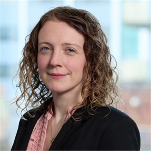 Rose-Marie Drury in a black jacket and pink top, in front of a window